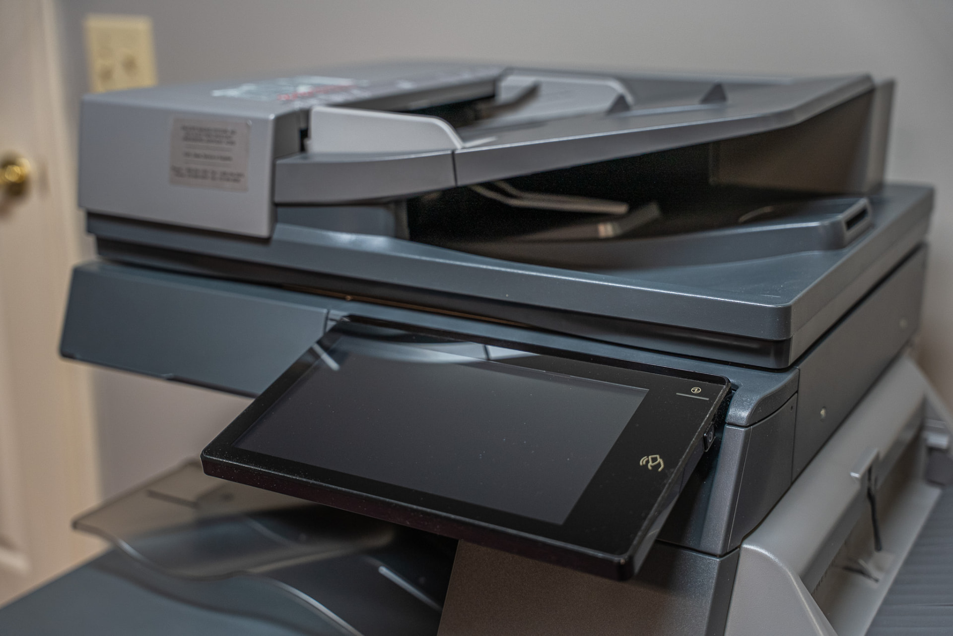 Close-up of a multifunction copier's touchscreen and document feeder